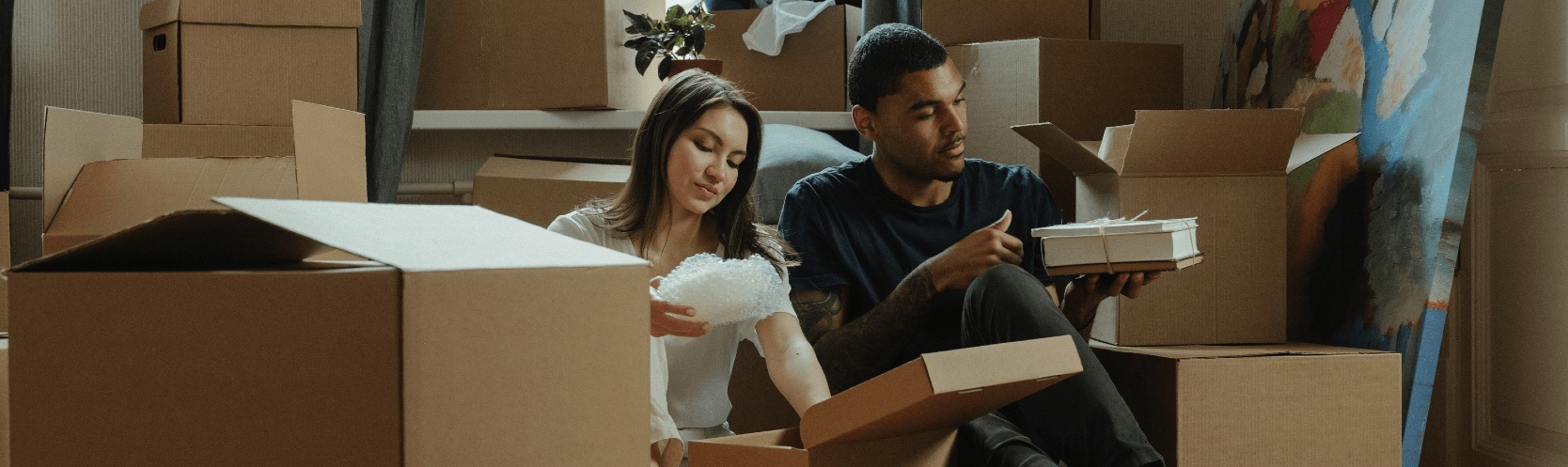 A couple unpacking boxes at their 5% deposit home