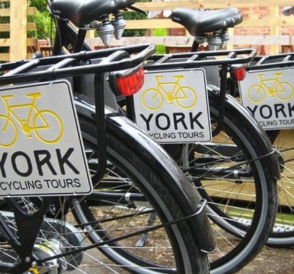 Bicycles with signs on them that say "YORK cycling tours"